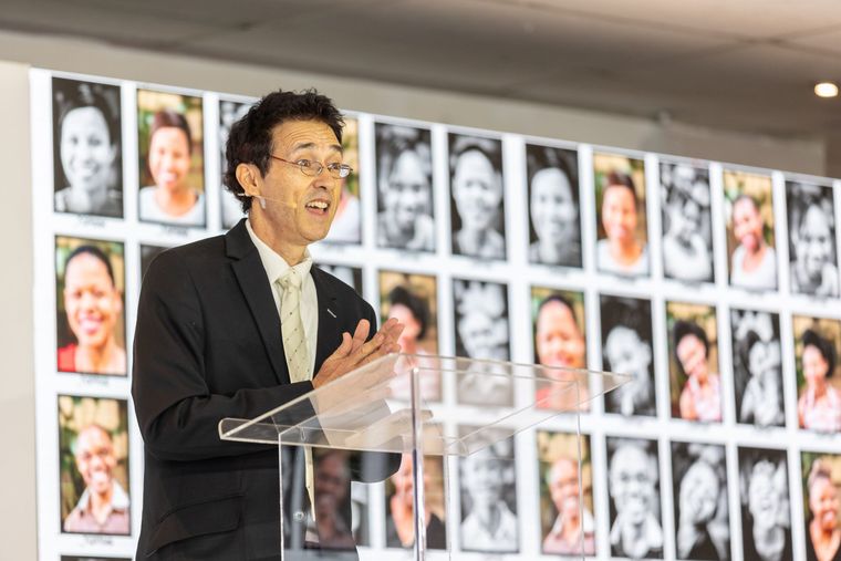 Taddy Blecher standing on a stage speaking